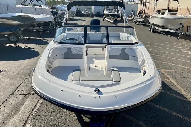 Slide: The Image of 2026 Bayliner VR4 Bowrider OB boat in a marina, showcasing sleek design and spacious seating. - 21