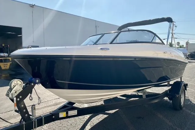 Slide: The Image of 2026 Bayliner VR4 Bowrider OB on trailer, sleek design, parked outdoors. - 3