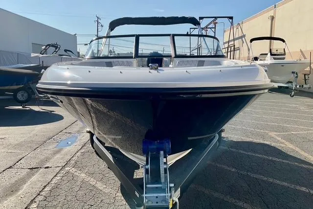 Slide: The Image of 2026 Bayliner VR4 Bowrider OB on trailer, parked outdoors in a marina. - 4