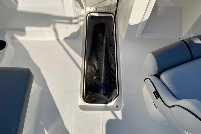 Slide: The Image of 2026 Bayliner VR4 Bowrider OB interior storage compartment with seating. - 7