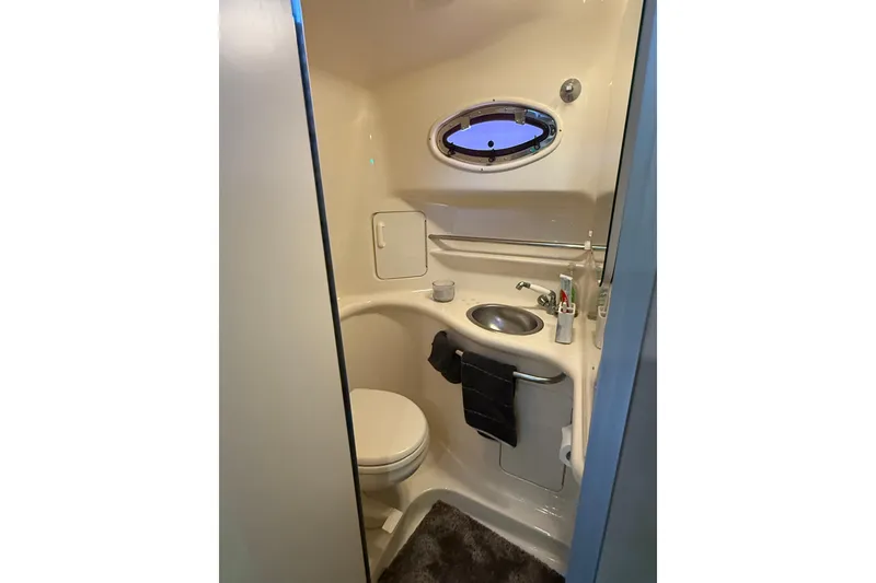 Slide: The Image of Bathroom interior of 1996 Sea Ray 330 Sundancer yacht, featuring sink and toilet. - 15