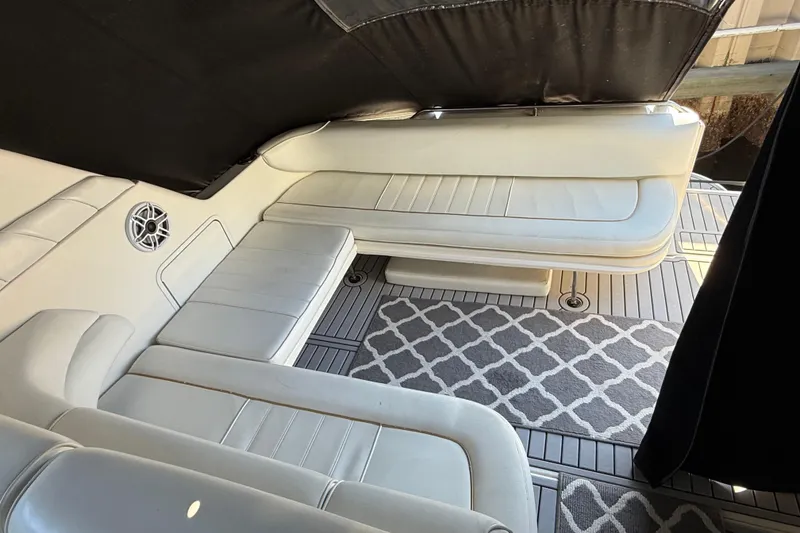 Slide: The Image of 1996 Sea Ray 330 Sundancer interior with white seating and patterned carpet. - 2