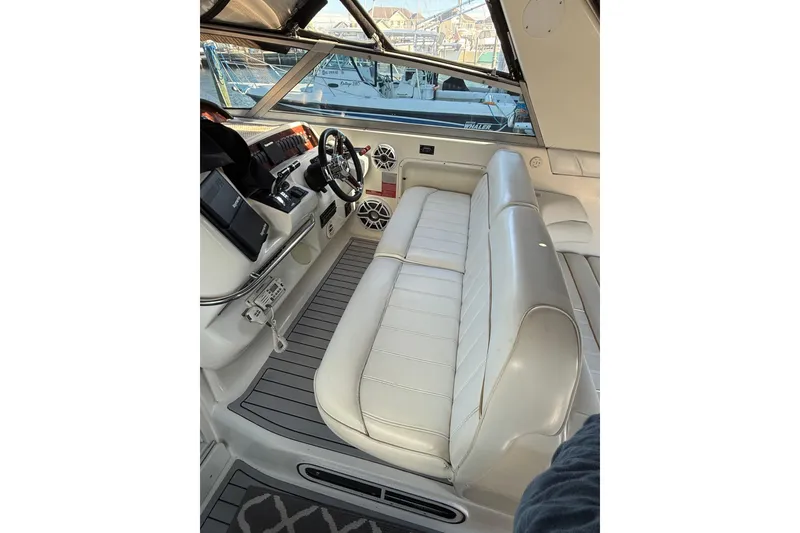 Slide: The Image of 1996 Sea Ray 330 Sundancer cockpit with white seating and modern controls. - 4