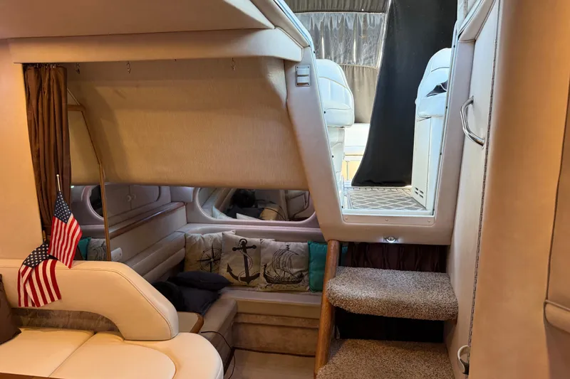 Slide: The Image of Interior of 1996 Sea Ray 330 Sundancer yacht with cozy seating and nautical decor. - 9