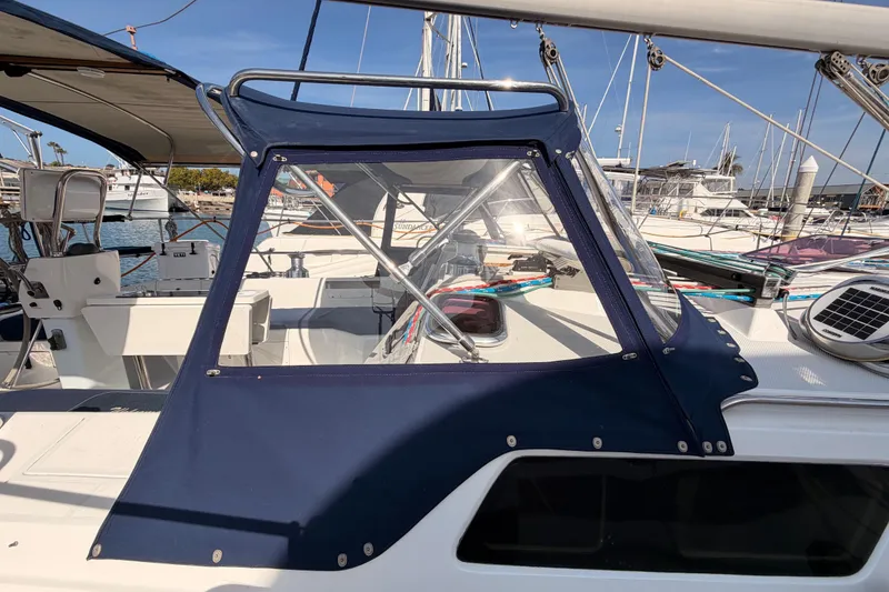 Slide: The Image of 2005 Catalina 42 MkII sailboat cockpit with blue canvas cover in marina setting. - 11