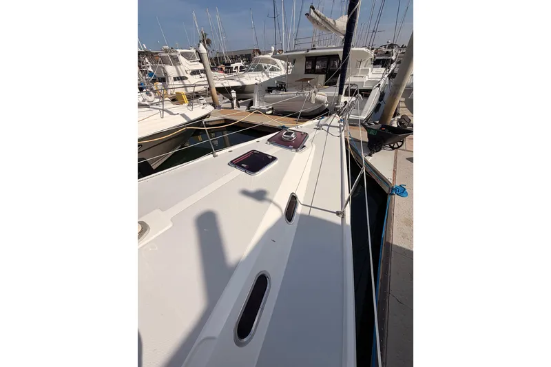 Slide: The Image of 2005 Catalina 42 MkII sailboat docked in a marina, showcasing deck and rigging. - 12