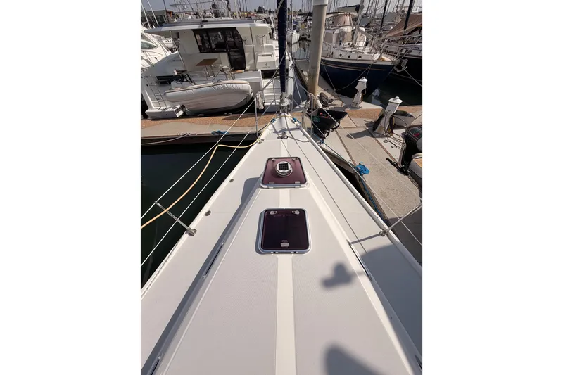 Slide: The Image of 2005 Catalina 42 MkII sailboat deck view at marina, showcasing hatches and rigging. - 13