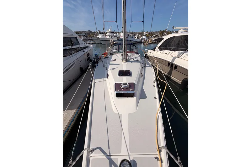 Slide: The Image of 2005 Catalina 42 MkII sailboat docked in a marina, surrounded by other boats. - 16