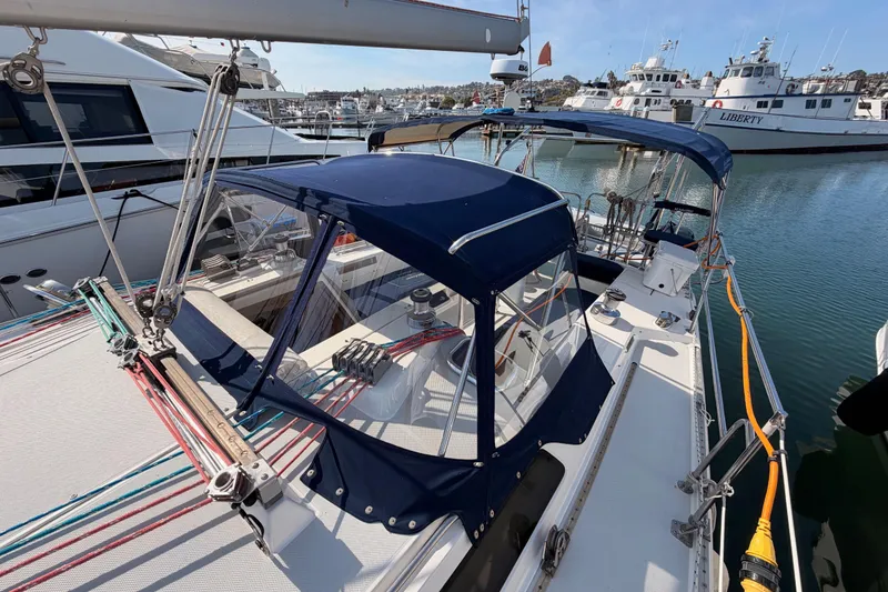 Slide: The Image of 2005 Catalina 42 MkII sailboat docked in marina, featuring blue canvas covers. - 20