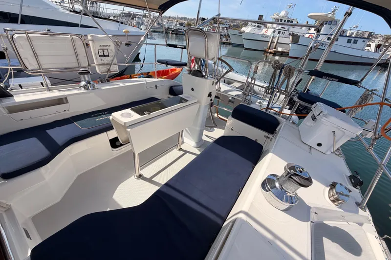 Slide: The Image of Cockpit of 2005 Catalina 42 MkII sailboat docked in marina, featuring seating and equipment. - 21