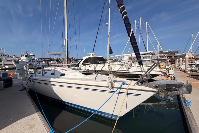Slide: The Image of 2005 Catalina 42 MkII sailboat docked at marina under clear blue sky. - 3