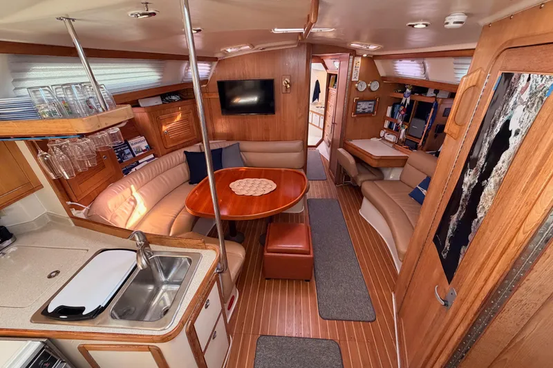 Slide: The Image of Luxurious interior of 2005 Catalina 42 MkII sailboat with wood finishes and cozy seating. - 34