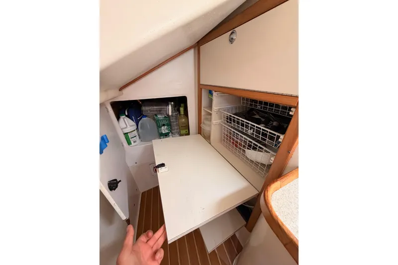 Slide: The Image of Interior storage space of a 2005 Catalina 42 MkII sailboat, featuring shelves and organized items. - 40