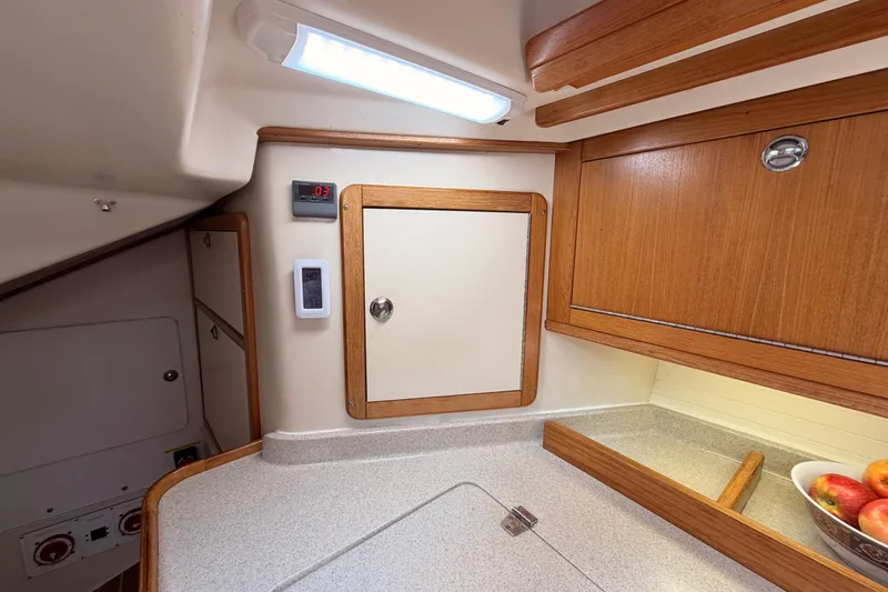 Slide: The Image of Interior of 2005 Catalina 42 MkII sailboat galley with wooden cabinets and countertop. - 41