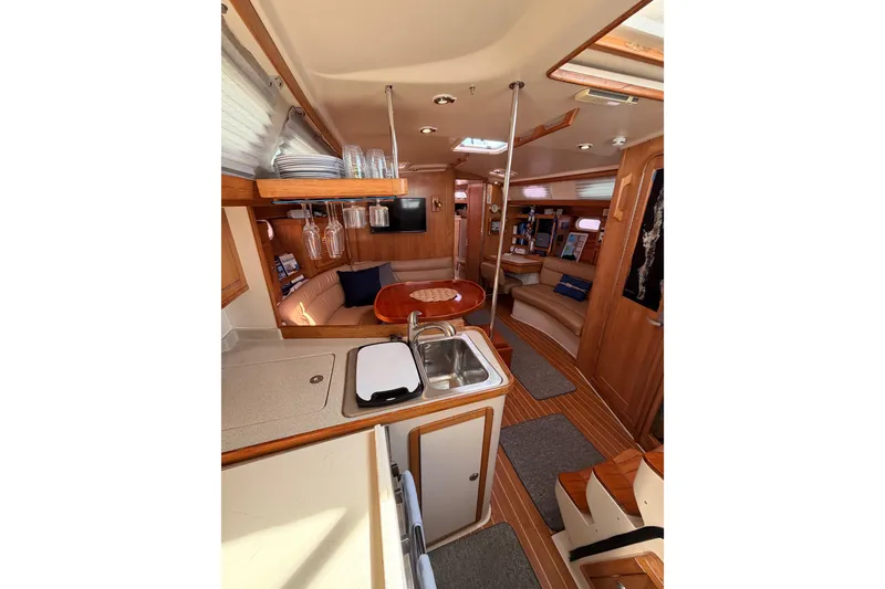 Slide: The Image of Interior of 2005 Catalina 42 MkII sailboat with cozy seating and modern kitchen amenities. - 46
