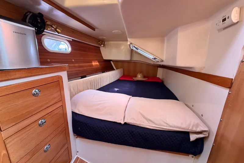 Slide: The Image of Cozy cabin interior of 2005 Catalina 42 MkII sailboat with bed and wooden cabinetry. - 49