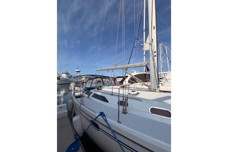 Slide: The Image of 2005 Catalina 42 MkII sailboat docked at marina under clear blue sky. - 5