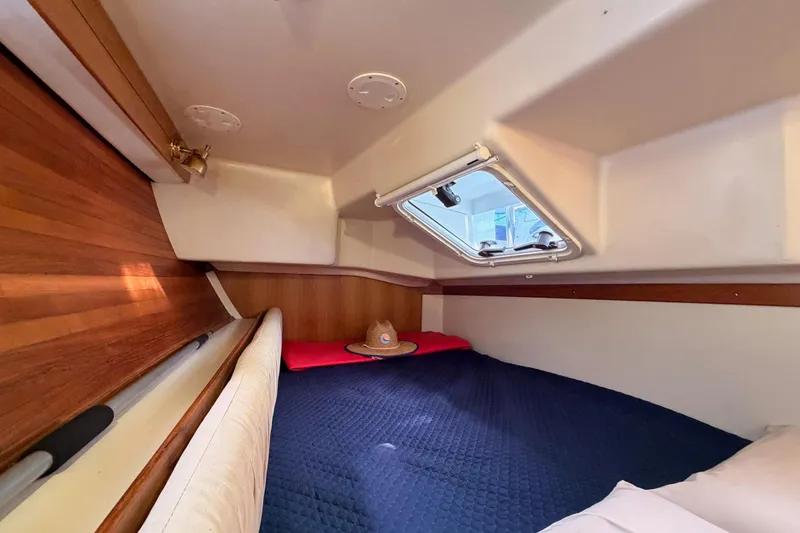 Slide: The Image of Cozy cabin interior of 2005 Catalina 42 MkII sailboat with wooden accents and bedding. - 50