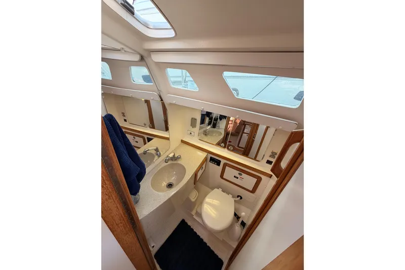 Slide: The Image of Catalina 42 MkII 2005 yacht bathroom with sink, toilet, and mirror. - 53