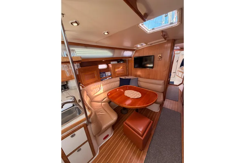 Slide: The Image of Interior of 2005 Catalina 42 MkII sailboat with cozy dining area and modern amenities. - 54