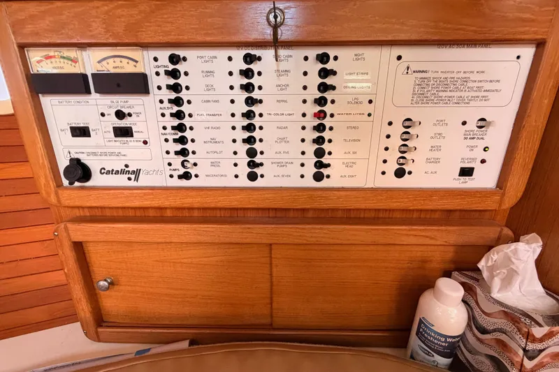 Slide: The Image of Control panel of a 2005 Catalina 42 MkII yacht with various switches and gauges. - 58