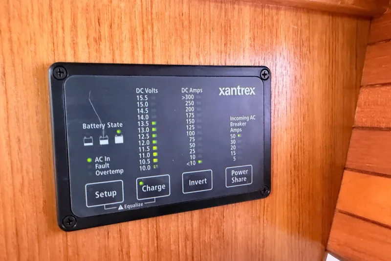 Slide: The Image of Xantrex power panel on 2005 Catalina 42 MkII sailboat, displaying battery and AC information. - 59