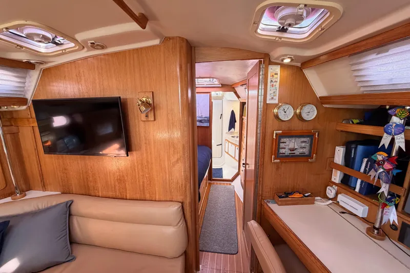 Slide: The Image of Interior of 2005 Catalina 42 MkII sailboat with cozy seating and navigation instruments. - 63