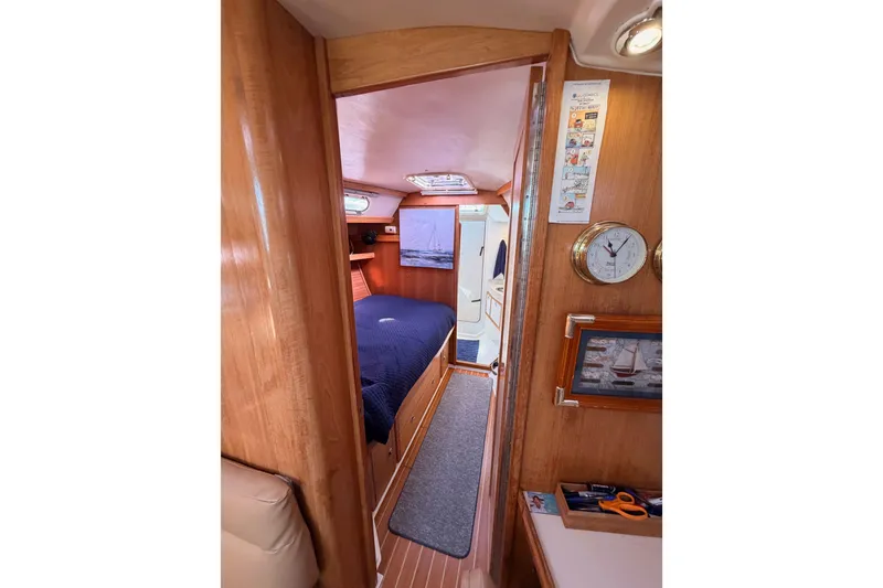 Slide: The Image of Interior of 2005 Catalina 42 MkII sailboat, featuring cozy cabin with wooden finishes. - 64