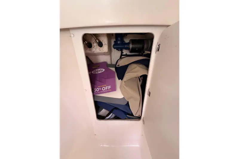 Slide: The Image of Storage compartment in a 2005 Catalina 42 MkII sailboat with miscellaneous items. - 71