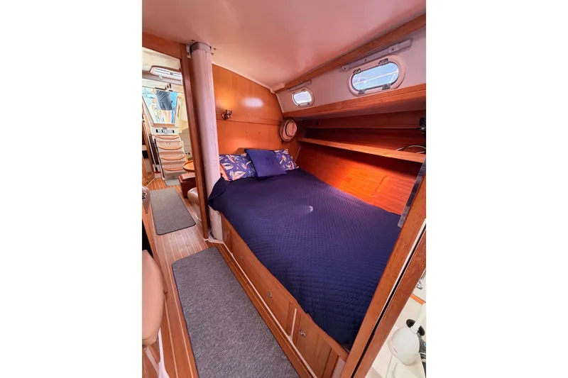 Slide: The Image of Cozy cabin interior of 2005 Catalina 42 MkII sailboat with blue bedding and wooden accents. - 75