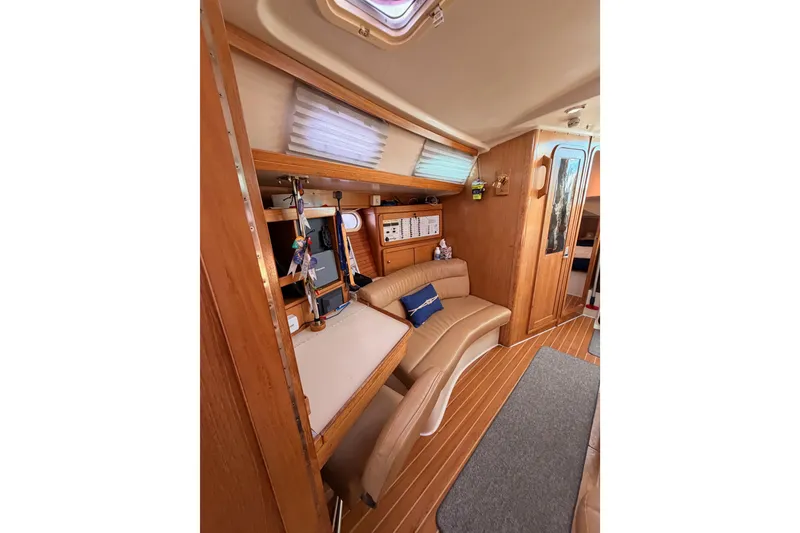 Slide: The Image of Interior of 2005 Catalina 42 MkII sailboat with cozy seating and wooden finishes. - 76