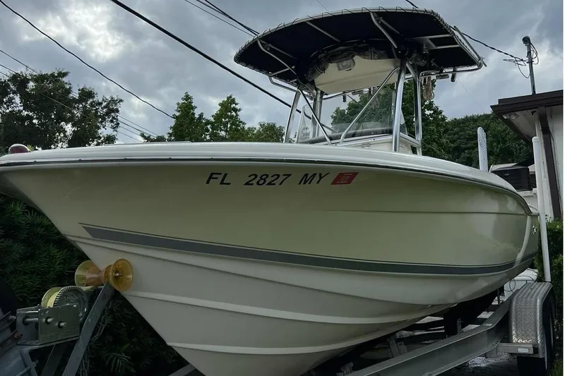 The Image of 2005 Scout 210 Sportfish boat on trailer, overcast sky background. - 0