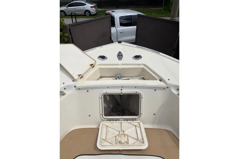 Slide: The Image of 2005 Scout 210 Sportfish boat deck with open storage compartments. - 11