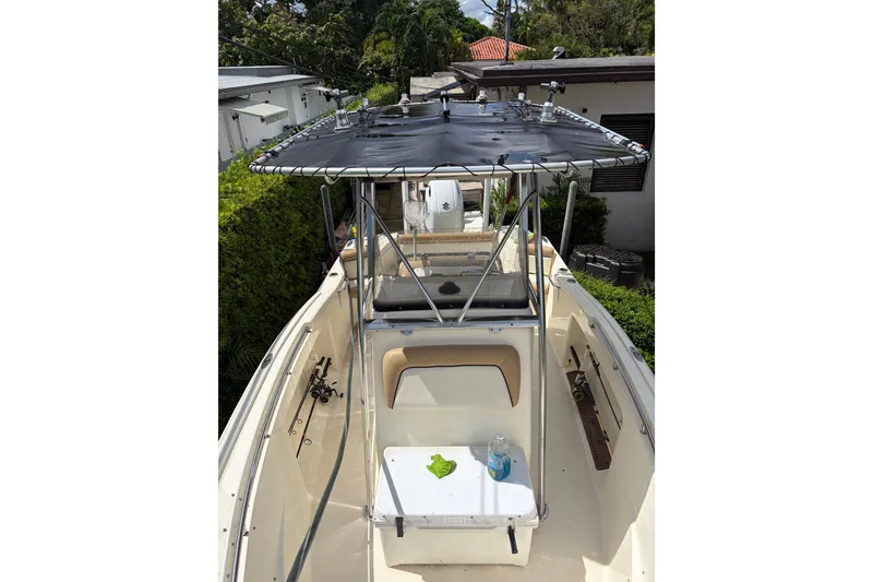 Slide: The Image of 2005 Scout 210 Sportfish boat with T-top and fishing gear, docked outdoors. - 8