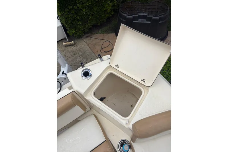 Slide: The Image of 2005 Scout 210 Sportfish boat with open storage compartment. - 9
