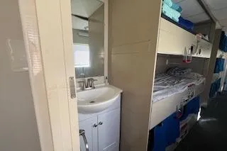 Slide: The Image of Starboard Guest Quarters sink and berth view. - 11