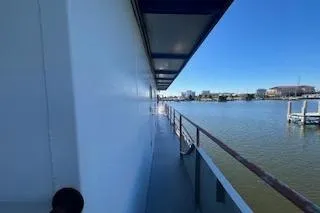 Slide: The Image of Side view of 1970 Blount 100 Foot Custom Steel Hull boat on calm water. - 45