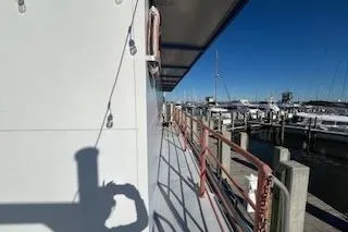 Slide: The Image of 1970 Blount 100 Foot Custom Steel Hull docked at marina under clear blue sky. - 62