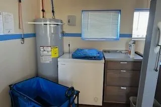 Slide: The Image of Laundry room on 1970 Blount 100 Foot Custom Steel Hull boat with appliances and storage. - 63