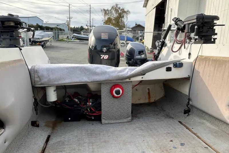 Slide: The Image of 1989 Olympic 17 Cabin boat interior with outboard motors and equipment. - 10