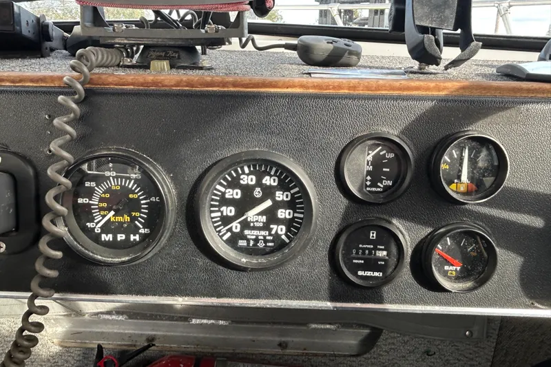 Slide: The Image of Dashboard of a 1989 Olympic 17 Cabin boat with various gauges and controls. - 7