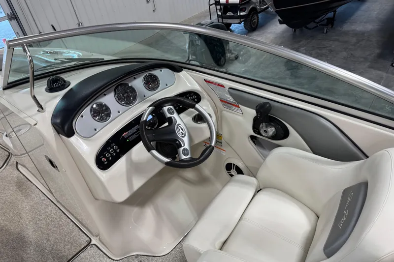 Slide: The Image of 2008 Sea Ray 240 Sundeck boat interior with steering wheel and dashboard controls. - 10