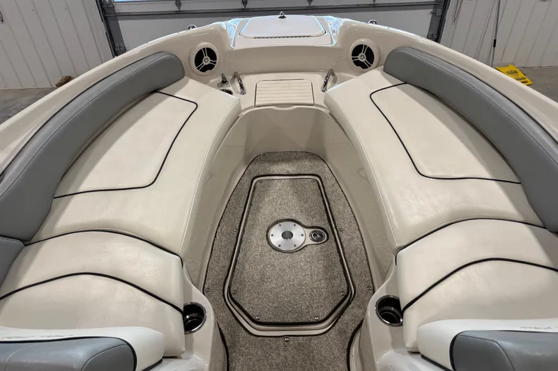 Slide: The Image of Interior of 2008 Sea Ray 240 Sundeck boat with cushioned seating and carpeted floor. - 11