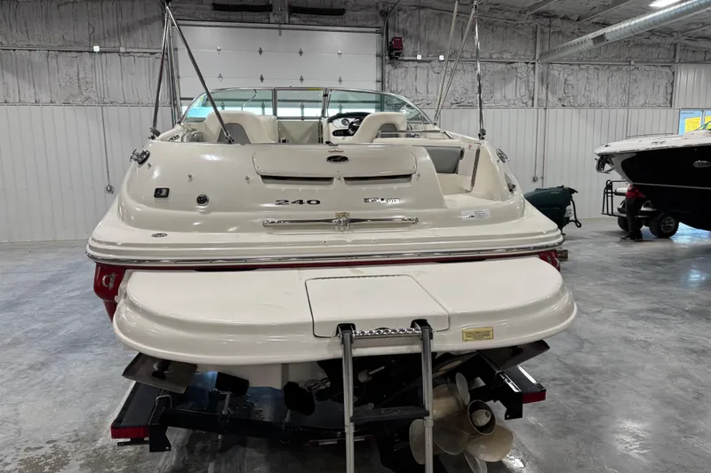 Slide: The Image of 2008 Sea Ray 240 Sundeck boat in a storage facility, rear view. - 5