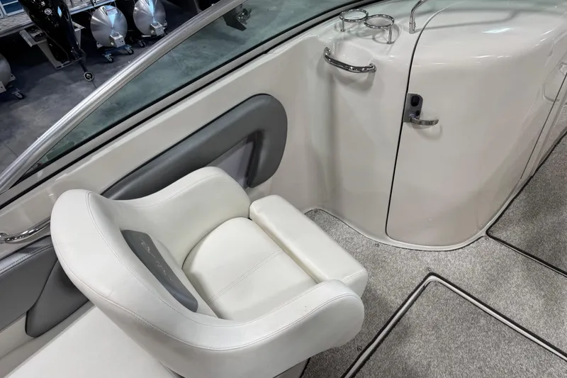 Slide: The Image of 2008 Sea Ray 240 Sundeck interior with white seating and cup holders. - 9