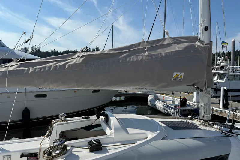Slide: The Image of Sailboat Dragonfly 25, 2022 model, docked with covered sail and clear sky. - 11