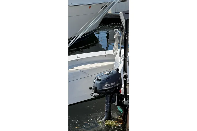 Slide: The Image of Outboard motor on a 2022 Dragonfly 25 boat, docked in a marina. - 16