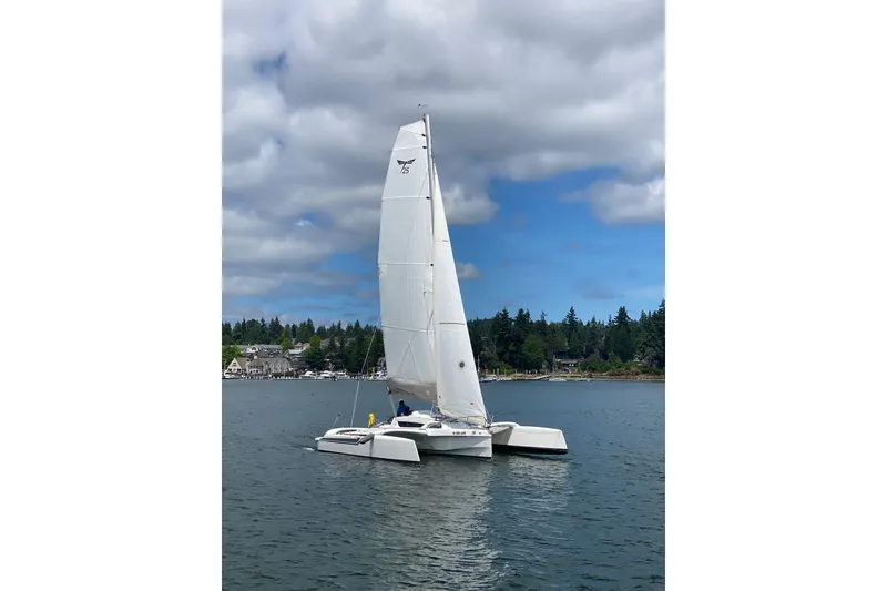 Slide: The Image of 2022 Dragonfly 25 sailboat on calm water under cloudy sky. - 2