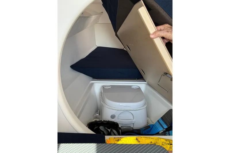 Slide: The Image of Compact cabin toilet in 2022 Dragonfly 25 sailboat, with storage space and seating. - 24