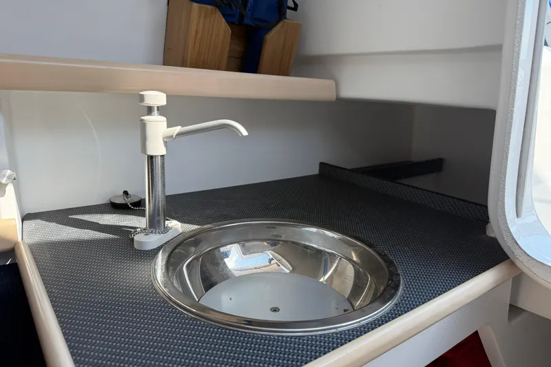 Slide: The Image of Compact sink area in 2022 Dragonfly 25 boat interior. - 25